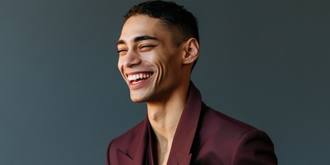Obraz premium Smiling young man portrait with dark gray background for banner poster background and wallpaper use in advertising and design