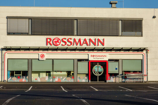Mulheim-Karlich, Germany - July13, 2026: Rossmann drugstore building displaying signage and window decorations with an empty parking lot on a sunny day