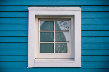 8K photo of a window on a old cottage in white and blue. A classic Swedish style of of home. Close up shot. © FigMedia