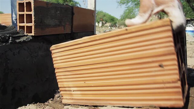 Close Up Shot of Bricklayer Testing Ceramic Brick Placement on Wall - 4K
