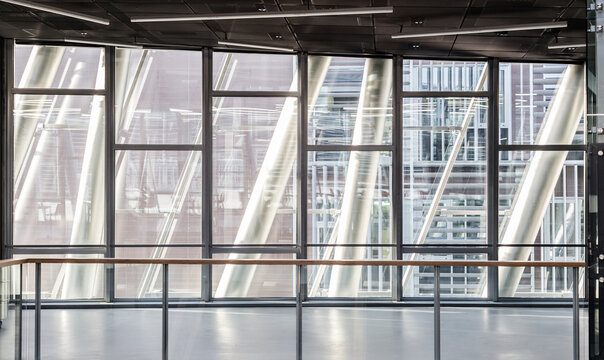 Abstract contemporary architecture or modern interior photograph. Geometric shapes and patterns formed by windows and railing on contemporary hallway.