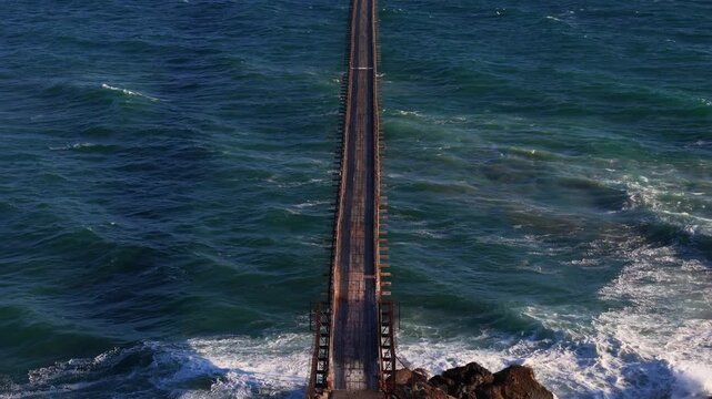 Ventura County, United States - 15 July 2026: Aerial view of the Rincon Island causeway extending into the Pacific Ocean with crashing waves.