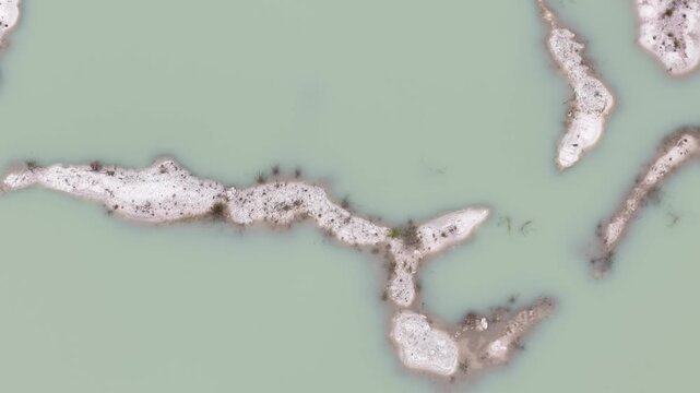 Kaolin Lake is an artificial lake formed from a former kaolin mining area. This lake is famous for its turquoise blue water which contrasts sharply with the white soil deposits around it.