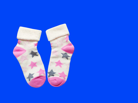 A pair of soft children's socks with a vibrant print. Cozy and warm knitted apparel for toddlers, isolated close-up shot. Concept of comfort, care, and kids' fashion.