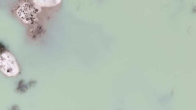 Kaolin Lake is an artificial lake formed from a former kaolin mining area. This lake is famous for its turquoise blue water which contrasts sharply with the white soil deposits around it.