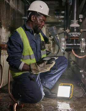 Utility Technician Conducting Underground Pipe Inspection with Ultrasonic Meter