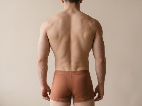 Muscular man back view. Athletic male torso showing strong back muscles and physique.