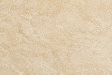 Fototapeta premium Beige Travertine Stone Surface with Natural Veining and Pitted Texture in Soft Overhead Lighting