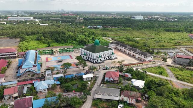 Aerial view of an Islamic boarding school with a large mosque inside