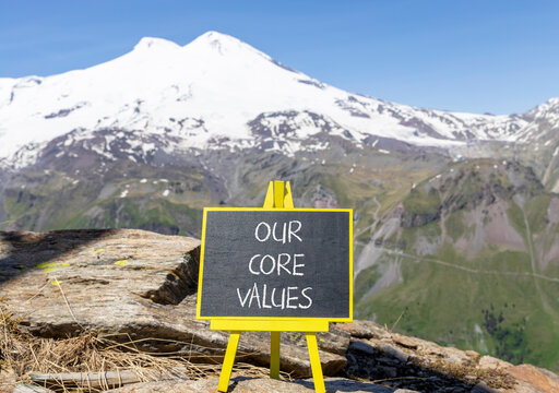 Our core values words symbol. Concept words Our core values on beautiful black blackboard. Beautiful mountain Elbrus sky background. Business our core values motivational support concept. Copy space.