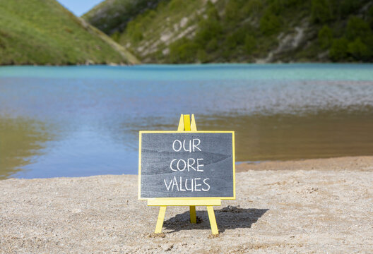 Our core values words symbol. Concept words Our core values on beautiful black blackboard. Beautiful mountain lake background. Business our core values motivational support concept. Copy space.