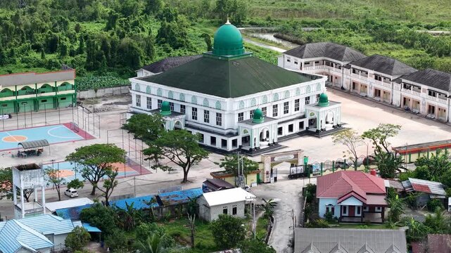 Aerial view of an Islamic boarding school with a large mosque inside