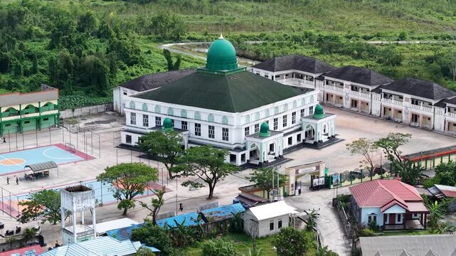 Aerial view of an Islamic boarding school with a large mosque inside