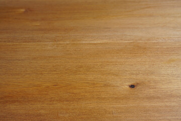 Obraz premium Light brown wooden surface with visible natural grain pattern and a small dark knot, creating a warm rustic background with copy space for product, food, and lifestyle designs