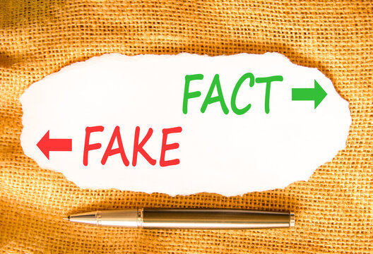 Fact or fake words symbol. Concept words Fake and Fact on beautiful white paper. Beautiful canvas background. Business and fact or fake concept. Copy space.