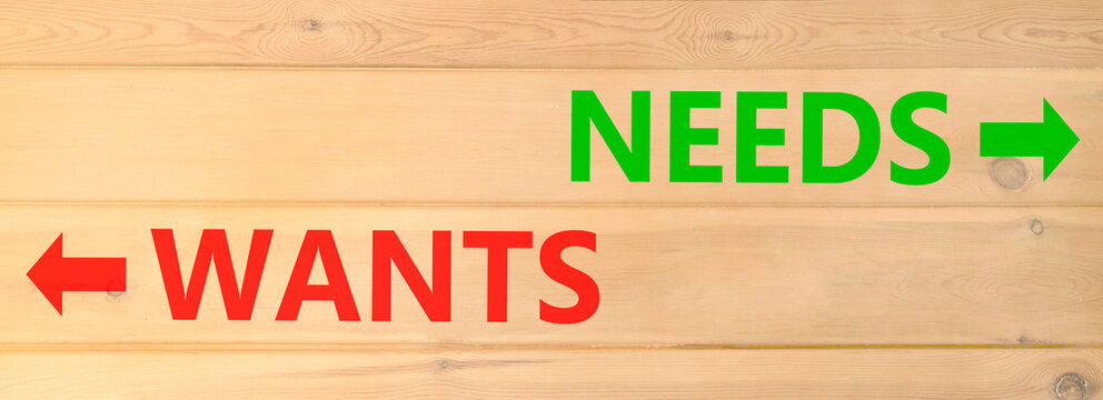 Needs instead wants words symbol. Concept words Needs Wants on beautiful wooden wall. Beautiful wooden wall background. Business psychology needs or wants concept. Copy space.