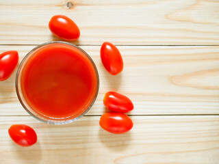 A glass of tomato juice on wooden table © Saranya