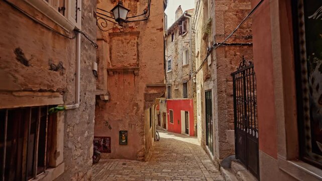Historic Narrow Alley with Colorful Facades in Rovinj Old Town, Croatia.Filmed on July 17, 2026.