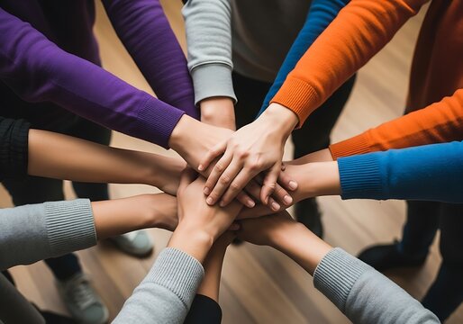 Diverse group stacking hands together. Team building concept showing unity and cooperation.