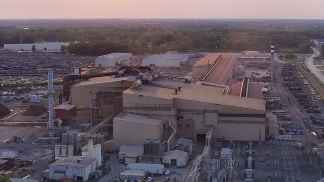 Monroe, Michigan, United States - 25 July 2026: Aerial view of Gerdau Special Steel Monroe industrial facility with metal manufacturing buildings, storage yards, and infrastructure at sunset.