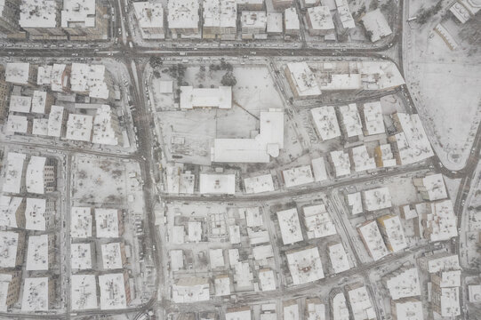 Karaman, Karaman, Turkey - 01 January 2026: Aerial view of Aktekke Millet Bahcesi surrounded by snow-covered residential buildings and streets in the city center.