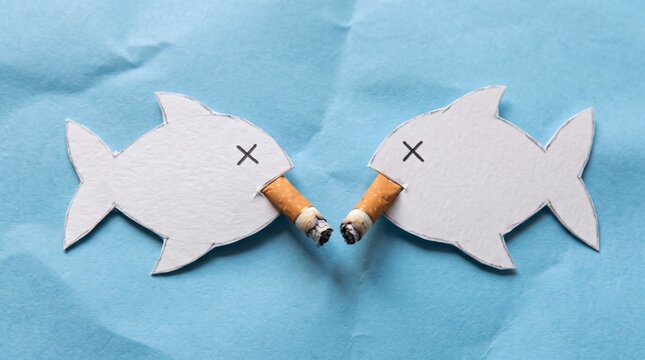 Two paper fish with cigarettes in their mouths and crossed eyes symbolizing pollution and environmental damage.