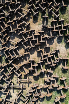Chattogram, Bangladesh - 26 February 2025: Aerial view of the Rail Yard featuring numerous discarded train wheelsets scattered across the ground, showing industrial textures and metallic components.