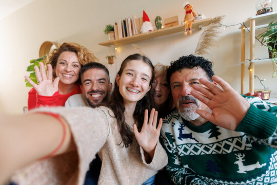 Multi generational family celebrating christmas holidays with a video call