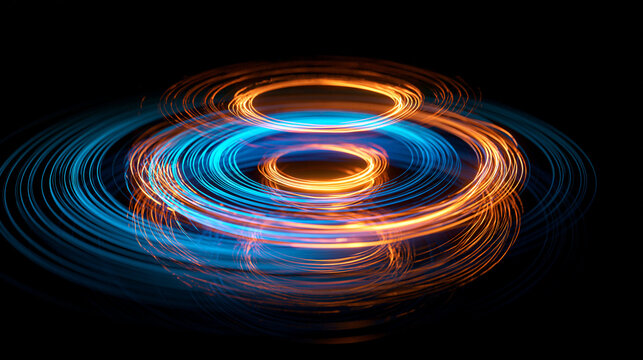 Layered orange and blue circular light trails spiraling on black background, abstract energy art