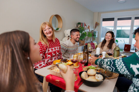 Family celebrating christmas dinner, enjoying festive holiday meal