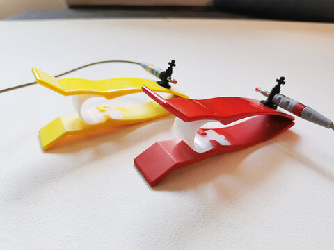 Two ECG electrodes clips on white background. Medical equipment for pulse measuring.
