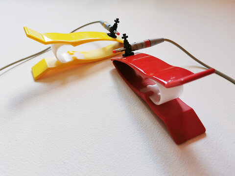 Two ECG electrodes clips on white background. Medical equipment for pulse measuring.