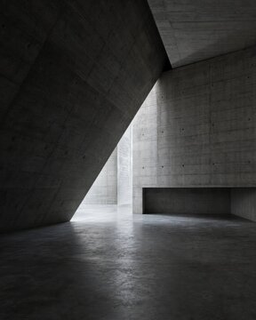 A minimalist interior featuring angular concrete walls and a bright light source illuminating the space.
