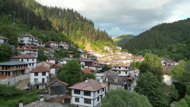 Drone Flight Revealing the Traditional Village of Shiroka Laka at Sunset, Rhodope Mountains Bulgaria