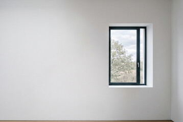 Fototapeta premium Single window in vast minimalist white wall, strong negative space composition