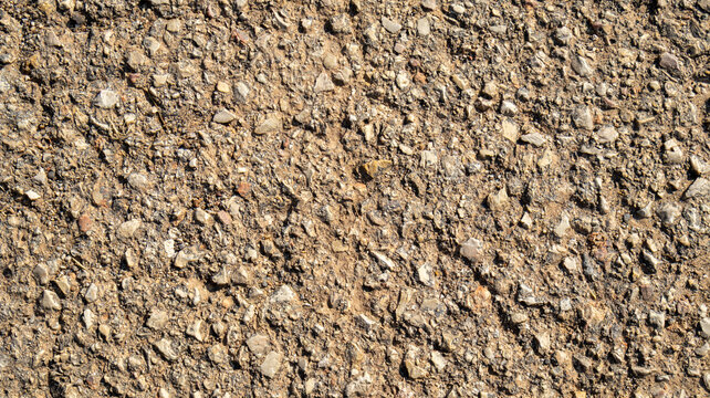 Textura de asfalto rugoso con piedras visibles