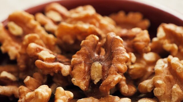 Close-up of peeled walnut kernels ready for consumption or cooking. Healthy snack and natural food ingredient. High quality 4k footage