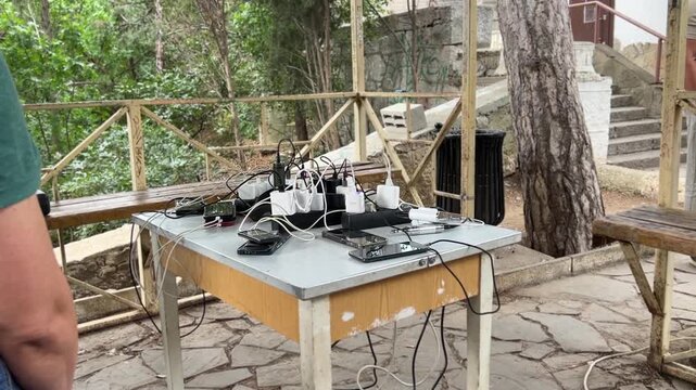 People Charging Smartphones at Community Support Center During Electricity Blackout