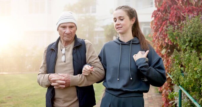 Walking, outdoor and woman with grandfather for wellness, mobility and fresh air at retirement center. Happy, morning and person with senior grandpa for talking, bonding and exercise for health