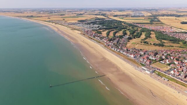 Aerial footage above Bridlington South Beach and promenade on sunny day