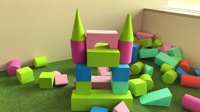 Bright tower made of colorful blocks in a children's counting play area, early learning activity, creative play, educational toy, childhood development.