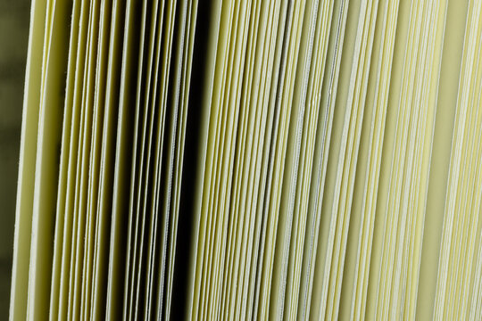 Close-up of book pages edge pattern texture background,Macro,Detailed close-up macro shot of the edge of pages in a thick book, creating a natural vertical line pattern, texture, and abstract backgrou