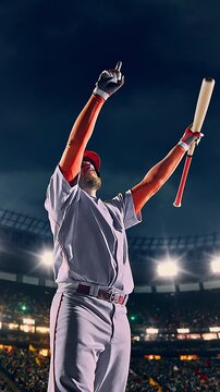 Baseball batter follow-through after swinging bat at night stadium