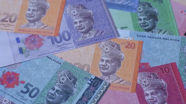 Malaysian ringgit banknotes as a tool for trade and financial transactions. The Malaysian ringgit as a background for your design