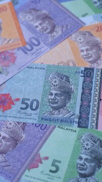 Malaysian ringgit banknotes as a tool for trade and financial transactions. The Malaysian ringgit as a background for your design