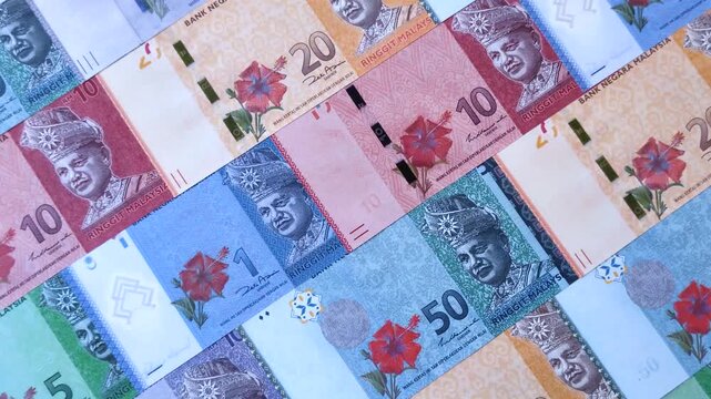 Malaysian ringgit banknotes as a tool for trade and financial transactions. The Malaysian ringgit as a background for your design