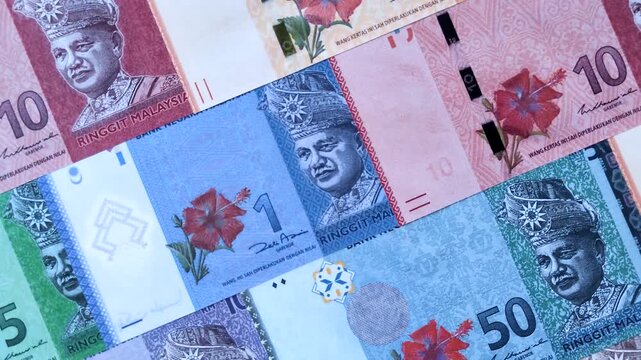 Malaysian ringgit banknotes as a tool for trade and financial transactions. The Malaysian ringgit as a background for your design
