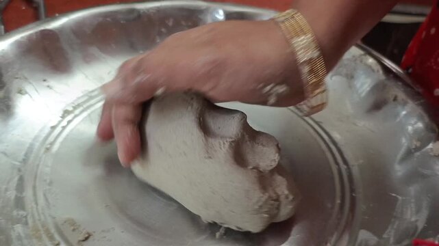 Indian Woman Kneading Bajra Dough and Hand Flattening Pearl Millet Bhakri Roti