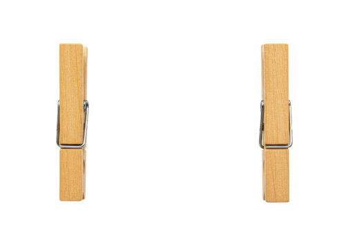 Macro shot of two wooden clothespins with shiny springs on a rustic jute rope against a white seamless backdrop. Minimalist still life concept