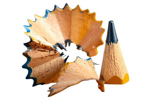 Sharpened Pencil Tip and Wood Shavings Isolated on a Solid Black Background